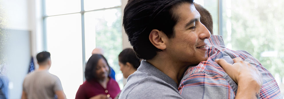 Two Men Hugging at an Event