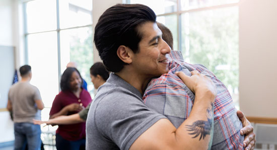 Two Men Hugging at an Event